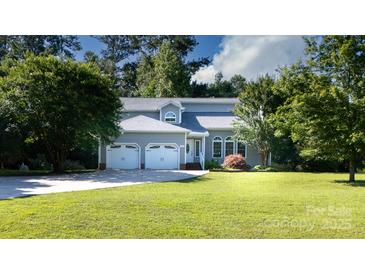 Charming gray home featuring a three-car garage and a well-manicured lawn and driveway at 2949 Glenstone Dr, Rock Hill, SC 29730