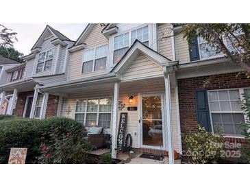 Charming townhome featuring a cozy front porch and well-maintained landscaping at 311 Wilkes Place Dr, Fort Mill, SC 29715