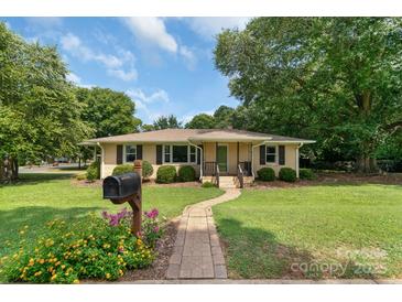Charming one-story home with a well-maintained front yard, brick walkway, and inviting curb appeal at 810 Lakeview Dr, Pineville, NC 28134