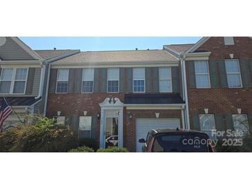 Charming brick townhome featuring a one-car garage and well-maintained landscaping at 162 Autumn Falls Dr, Lake Wylie, SC 29710