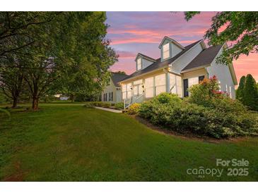 Charming home featuring a covered porch, well-maintained lawn, and lush landscaping, ideal for serene outdoor living at 315 Talon Dr, Salisbury, NC 28147
