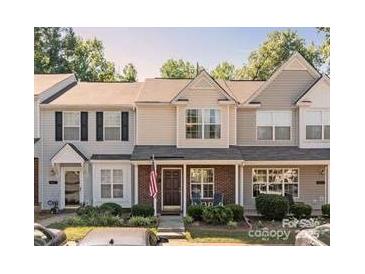 Charming townhome with well-maintained landscaping and traditional architectural details on a sunny day at 419 Scarlett Ln, Fort Mill, SC 29715