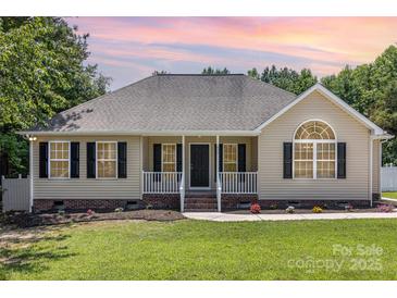 Charming single-story home with a manicured lawn, a welcoming porch, and black shutters at 608 Red Hawk Way, Clover, SC 29710