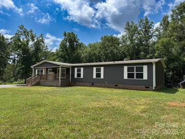 Charming single-story home features a covered porch and lush green lawn at 1856 Kemp Cir, Shelby, NC 28152