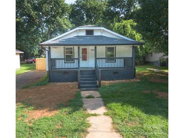 Charming single-story home with a cozy front porch and well-maintained lawn at 1919 Gay St, Statesville, NC 28625