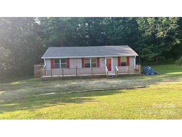 Charming home featuring a spacious wraparound deck, red shutters, and a well-maintained lawn at 2611 Dallas Stanley Hwy, Stanley, NC 28164