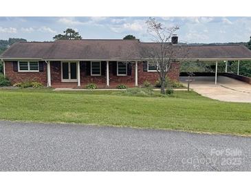 Charming brick ranch home with a cozy front porch, carport, and a well-maintained front yard at 114 Joe Teague Rd, Hickory, NC 28601