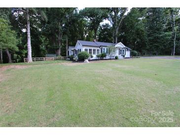 Charming white home featuring a well-maintained front yard and mature trees at 1257 Reese Roach Rd, Rock Hill, SC 29730