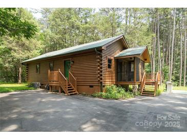 Charming log cabin home with a covered porch nestled among the trees at 164 Pleasant Creek Dr, Cleveland, NC 27013
