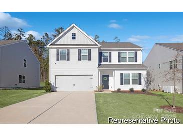Charming two-story home with a manicured lawn, driveway, and a two car garage at 4044 Beacon Ave # 152, Monroe, NC 28110