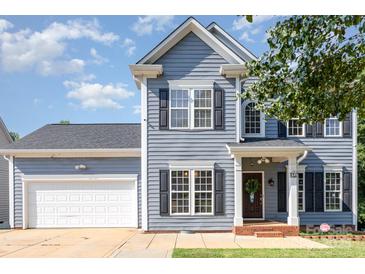 Charming two-story home with blue siding, black shutters, and well-maintained landscaping at 6930 Culloden More Ct, Charlotte, NC 28217