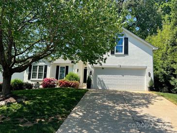 Charming white two-story home with a well-manicured lawn and a spacious two car garage at 21218 Baltic Dr, Cornelius, NC 28031