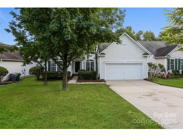 Charming home featuring a well-manicured lawn, mature trees, and a bright white exterior at 3422 Balsam Tree Dr, Charlotte, NC 28269