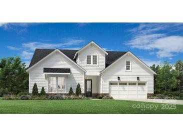 Charming, new construction two-story home with white siding, dark roof, and meticulously manicured lawn at 4161 Eastover Glen Rd # 0338, Charlotte, NC 28269