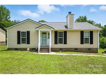 Charming single-story home with a well-manicured lawn and black shutters at 8106 Strawberry Point Dr, Charlotte, NC 28215