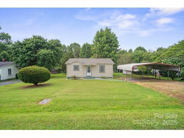 Charming single-story home featuring a well-manicured lawn and a convenient carport for covered parking at 2321 Cline St, Statesville, NC 28677