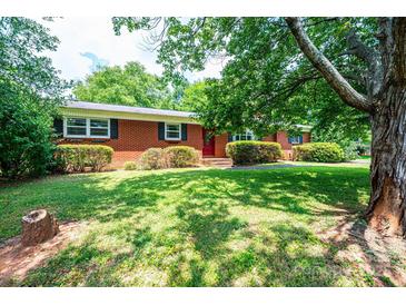 Charming brick home features a well-manicured lawn and mature shade trees at 1008 2Nd Se St, Conover, NC 28613