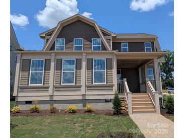Charming two-story home featuring large windows, neutral siding, and a welcoming front porch at 117 Macland Ln # 537, Rock Hill, SC 29730