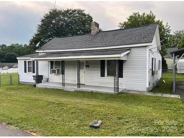 Cozy single-Gathering home with white siding, a well-maintained lawn, and a classic architectural style at 104 Franklin St, Clover, SC 29710