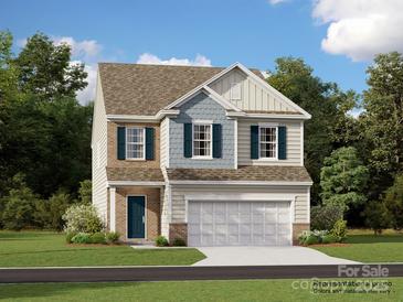 Charming two-story home featuring a blend of siding, brick accents, and a two-car garage at 1606 Swallow Tail Dr, Cramerton, NC 28012