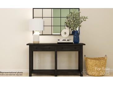 A hallway table is decorated with a lamp, vase, and stylish decor at 1616 Swallow Tail Dr, Cramerton, NC 28012