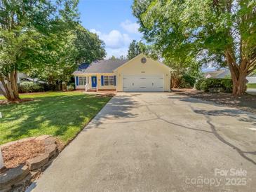 Charming home featuring blue shutters, a well-manicured lawn, and a long driveway, with mature trees offering shade at 1634 Dawson Ct, Rock Hill, SC 29730