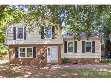 Charming two-story home with a brick facade and black shutters at 2508 Wood Star Ct, Matthews, NC 28105