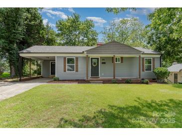 Charming single-story home featuring gray siding, a covered carport, and a well-maintained front lawn at 3015 Lasalle St, Charlotte, NC 28216