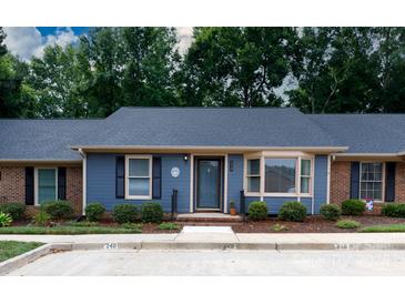 Charming single-story home with blue siding, black shutters, and a well-manicured front yard at 238 Pointe Cir, Rock Hill, SC 29732