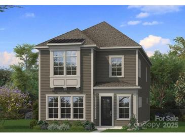 Charming two-story home with a well-manicured lawn and neutral siding, surrounded by lush greenery at 3127 Middle St # 95, Charlotte, NC 28278
