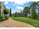 Landscaped backyard with paved pathway, lush lawn, and hedge at 18019 Harbor Light Blvd, Cornelius, NC 28031