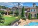 Spacious backyard featuring a custom-designed pool, lush landscaping, and a charming covered patio at 18019 Harbor Light Blvd, Cornelius, NC 28031
