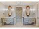 Ornate bathroom with custom cabinetry, dual vanities, decorative mirrors, and chandelier lighting at 18019 Harbor Light Blvd, Cornelius, NC 28031