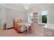 Charming bedroom with floral wallpaper, chandelier, and custom built-in shelving at 18019 Harbor Light Blvd, Cornelius, NC 28031