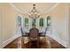 Formal dining area with a striking chandelier, hardwood flooring and a curved wall of windows at 18019 Harbor Light Blvd, Cornelius, NC 28031