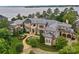 Stunning lakefront home features professionally landscaped grounds with elegant stonework and a meticulously maintained lawn at 18019 Harbor Light Blvd, Cornelius, NC 28031