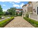 Stately home shows manicured greenery, a stone facade, arched entryways, and courtyard access at 18019 Harbor Light Blvd, Cornelius, NC 28031