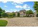 Grand home with circular driveway and professionally landscaped grounds, offering elegant curb appeal at 18019 Harbor Light Blvd, Cornelius, NC 28031