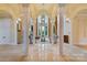Grand foyer with soaring ceilings, elegant columns, a fireplace, and marble floors at 18019 Harbor Light Blvd, Cornelius, NC 28031