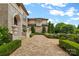 Elegant home exterior with manicured greenery along a brick walkway at 18019 Harbor Light Blvd, Cornelius, NC 28031