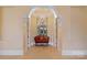 Elegant hallway with arched entryway and a cozy settee at 18019 Harbor Light Blvd, Cornelius, NC 28031