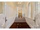 Elegant hallway features gleaming hardwood floors, detailed molding and archways that add architectural interest at 18019 Harbor Light Blvd, Cornelius, NC 28031