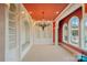 Elegant library with built-in bookshelves, a window seat, and a stunning chandelier at 18019 Harbor Light Blvd, Cornelius, NC 28031