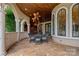 Covered patio with arched entryway, wicker furniture, and ceiling fan at 18019 Harbor Light Blvd, Cornelius, NC 28031