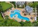 Aerial view of unique pool with spa, sundeck, adjacent pool house, and outdoor dining area at 18019 Harbor Light Blvd, Cornelius, NC 28031