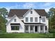 New construction home boasts a white exterior, black accents, and a beautifully manicured front yard at 11318 James Coy Rd # Devonshire, Davidson, NC 28036
