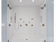Large walk-in shower with multiple shower heads and a tiled bench at 11318 James Coy Rd # Devonshire, Davidson, NC 28036