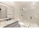 Modern bathroom featuring a glass-enclosed shower and granite countertop sink at 8159 Fairview Rd, Charlotte, NC 28226