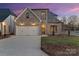 Charming brick home featuring an attached two-car garage and well-maintained landscaping at 8159 Fairview Rd, Charlotte, NC 28226