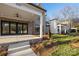 Charming front porch with brick accents and manicured landscaping at 8159 Fairview Rd, Charlotte, NC 28226